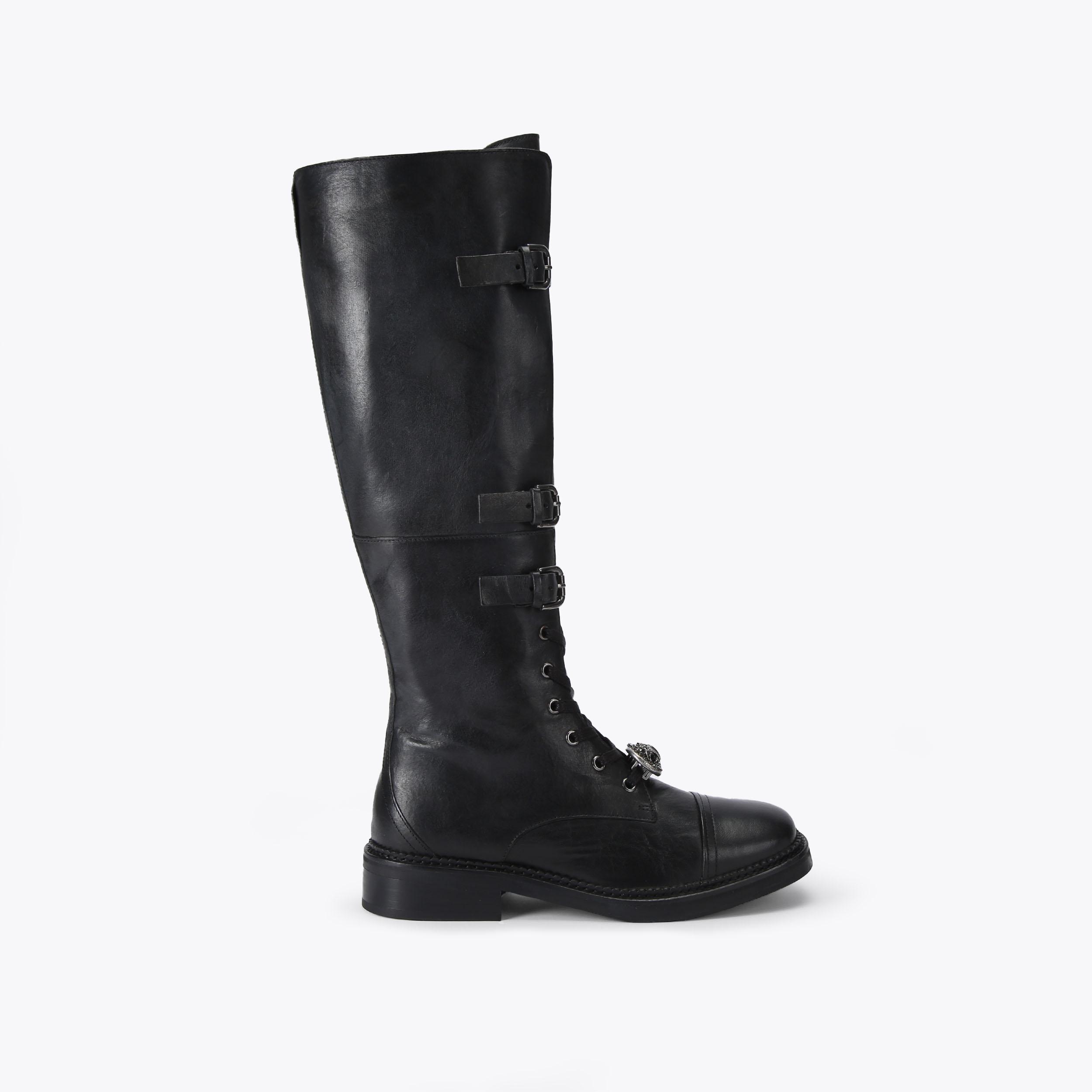 Kurt Geiger Monument Strap Boot in black leather showcasing the brand's signature design elements